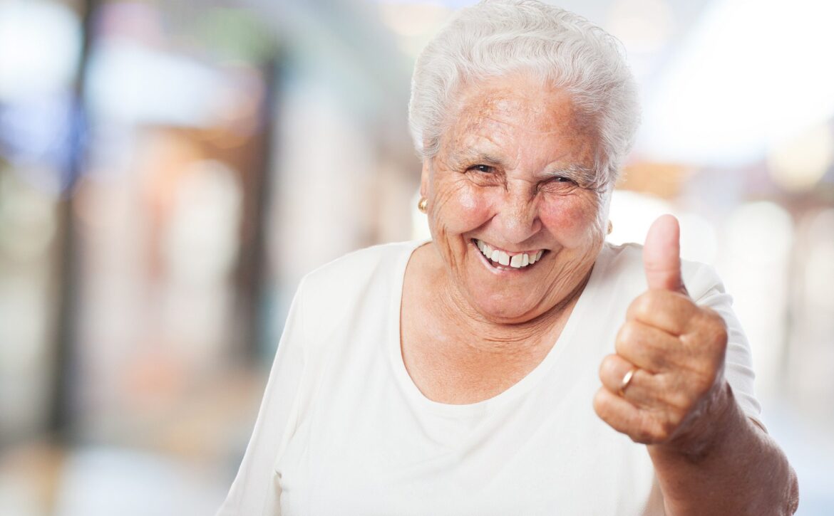 happy old woman with thumb up closeup
